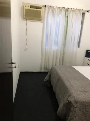 Uma cama ou camas num quarto em Quartos a 50 metros da praia