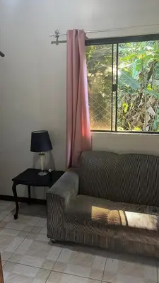 Uma área de estar em Quarto ECONÔMICO - Suíte