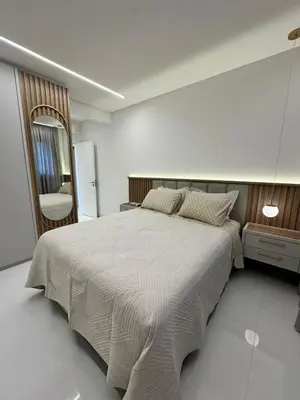 Uma cama ou camas num quarto em Apartamento no coração de Meia Praia, com 4 Suítes e 3 vagas de garagem