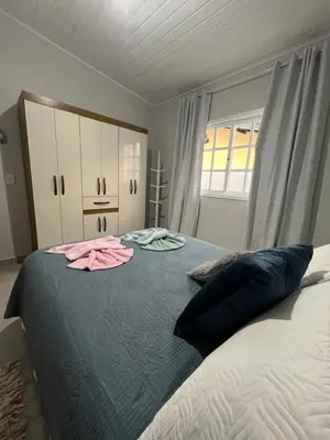 Uma cama ou camas num quarto em Casa de Praia 63 - Nelson