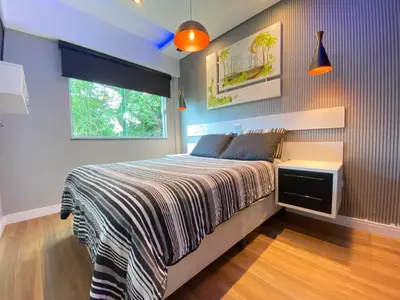 Uma cama ou camas num quarto em Duplex com piscina na praia de Bombinhas