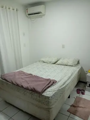 Uma cama ou camas num quarto em Apartamento Itapema