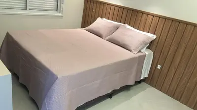 Uma cama ou camas num quarto em Apartamento praia de Palmas
