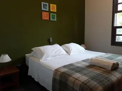 Uma cama ou camas num quarto em Cabanas Do Araçá Villa