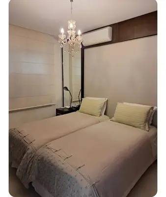 Uma cama ou camas num quarto em Apartamento lindo de Frente para o Mar