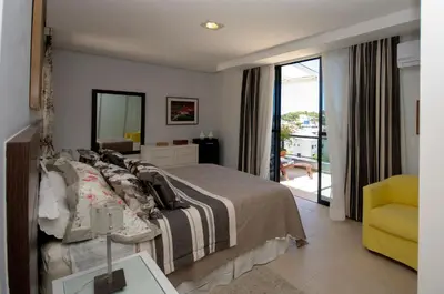 Uma cama ou camas num quarto em Ed Baia Azul Centro Bombinhas