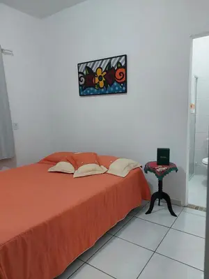 Uma cama ou camas num quarto em Porto Belo Perequê