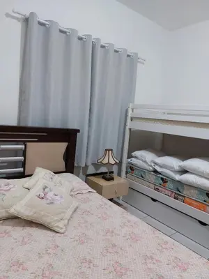 Uma cama ou camas num quarto em Porto Belo Perequê
