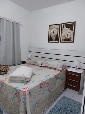 Uma cama ou camas num quarto em Porto Belo Perequê