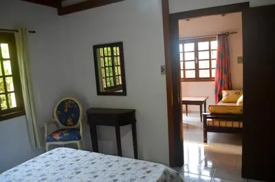 Uma cama ou camas num quarto em Sobrado Familiar da Salete 01