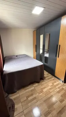 Uma cama ou camas num quarto em Casa de temporada