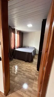 Uma cama ou camas num quarto em Casa de temporada