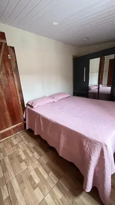 Uma cama ou camas num quarto em Casa de temporada