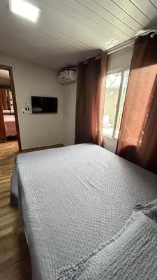 Uma cama ou camas num quarto em Casa de temporada