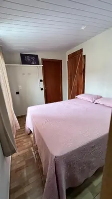 Uma cama ou camas num quarto em Casa de temporada