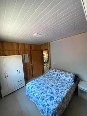 Uma cama ou camas num quarto em Casa Aluguel Porto Belo