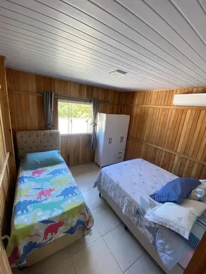 Uma cama ou camas num quarto em Casa Aluguel Porto Belo