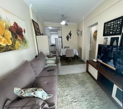 Uma televisão e/ou sistema de entretenimento em Apartamento 150m da Praia