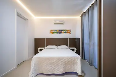 Uma cama ou camas num quarto em Seu Paraíso em Bombinhas Apto Totalmente Equipado a 3 Minutos da Areia