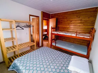 Uma cama ou camas num quarto em Casa Piscina Bombinhas 10 Pessoas