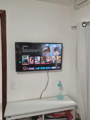 Uma televisão e/ou sistema de entretenimento em Apartamento Itapema centro