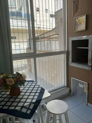 Uma televisão e/ou sistema de entretenimento em Apartamento Itapema centro