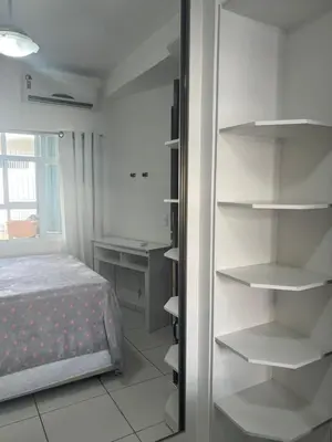 Uma cama ou camas num quarto em Apartamento Itapema centro