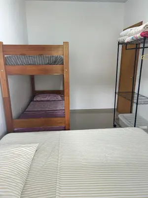 Uma cama ou camas num quarto em Casa de Praia, a 250 metros do mar, com piscina exclusiva
