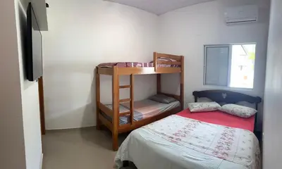 Uma cama ou camas num quarto em Casa de Praia, a 250 metros do mar, com piscina exclusiva