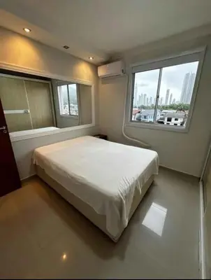 Uma cama ou camas num quarto em Edifício Bella Praia 1