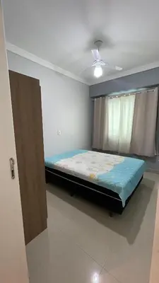 Uma cama ou camas num quarto em Apartamento Porto Belo