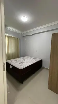 Uma cama ou camas num quarto em Apartamento Porto Belo