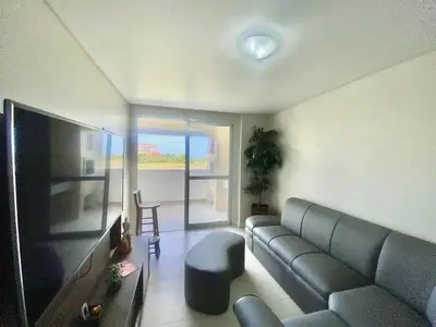 Uma televisão e/ou sistema de entretenimento em Palmas Maravilhoso Beach Apartment!