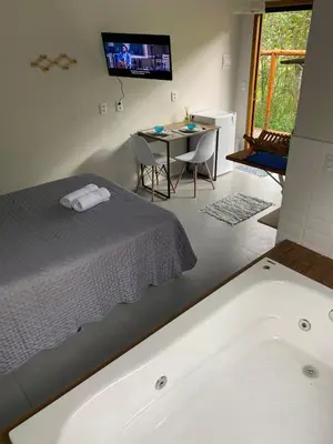 Uma cama ou camas num quarto em Loft Para Casais com Jacuzzi - Geminado - Unidade 2 Sunset - Sem Café da Manã
