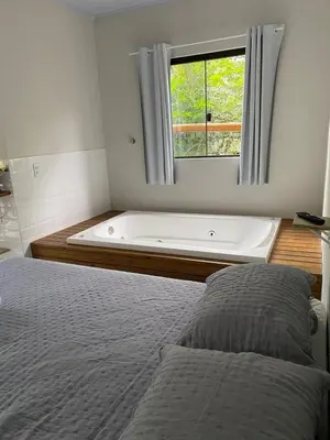 Uma cama ou camas num quarto em Loft Para Casais com Jacuzzi - Geminado - Unidade 2 Sunset - Sem Café da Manã