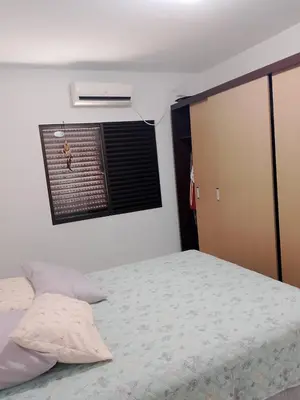 Uma cama ou camas num quarto em Sobrado Bombinhas 80m da praia