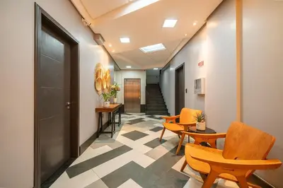 Uma área de estar em Achei Itapema • Dona Nina Residencial, R.255