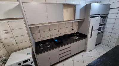 A cozinha ou kitchenette de Apartamento pé na areia em Meia Praia com churrasqueira com vista mar