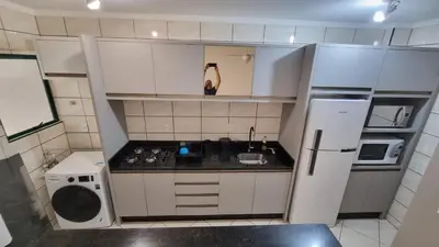 A cozinha ou kitchenette de Apartamento pé na areia em Meia Praia com churrasqueira com vista mar