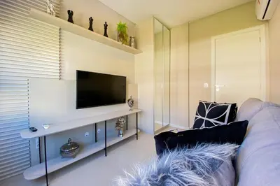 Uma televisão e/ou sistema de entretenimento em Apartamento em home clube