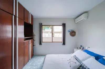Uma cama ou camas num quarto em Praia de Palmas, Ampla Casa Piscina Privativa - 0404