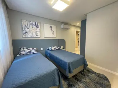 Uma cama ou camas num quarto em Vista Mar - 4 Suites em Itapema
