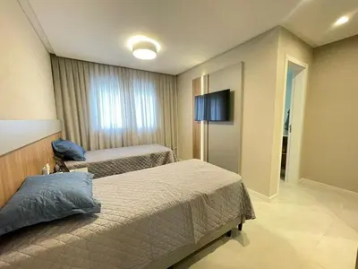 Uma cama ou camas num quarto em Vista Mar - 4 Suites em Itapema