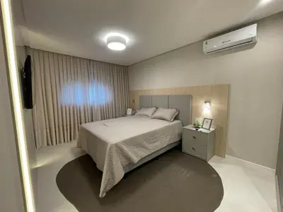 Uma cama ou camas num quarto em Vista Mar - 4 Suites em Itapema