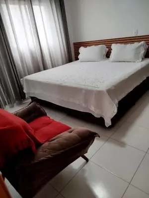 Uma cama ou camas num quarto em Condomínio Boulevard das Palmeiras