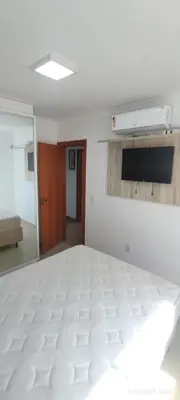 Uma cama ou camas num quarto em Apartamento elegante perto do mar