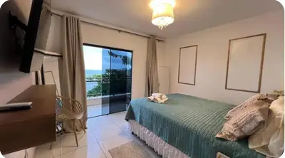 Uma cama ou camas num quarto em Ap frente mar Meia praia