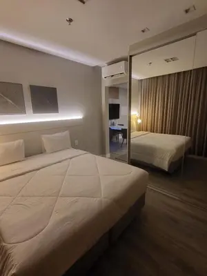 Uma cama ou camas num quarto em Flat Tower Infinity Meia Praia