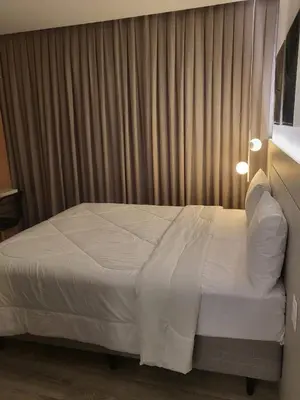 Uma cama ou camas num quarto em Flat Tower Infinity Meia Praia