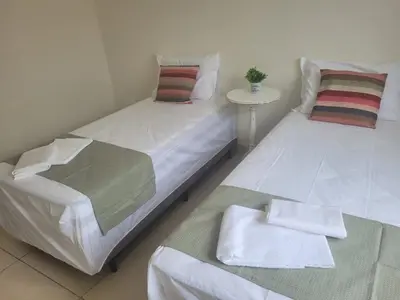 Uma cama ou camas num quarto em Pousada Jardim